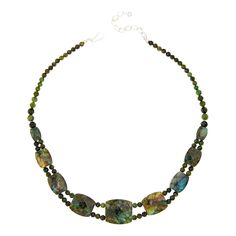 Jay King Nephrite Jade and Labradorite Reversible Necklace Gorgeous green nephrite jade and lovely labradorite together create a fun styling option with two unique looks in one versatile design. Simply reverse the necklace to change up your look! From Jay King.       Approx. 18"L x 15/16"W with 2-3/4" extender     Stamped .925     Hook closure     Dark green nephrite jade necklace has nine double-sided, barrel-shaped, faceted stations along drape     Each station has multicolor labradorite on on Green Chrysocolla Gemstone Beads Jewelry, Spiritual Green Labradorite Necklaces, Spiritual Green Labradorite Necklace, Green Labradorite Necklaces With Natural Stones, Green Gemstone Jewelry With Labradorite, Unique Looks, Necklace Stone, Single Bead, Nephrite Jade