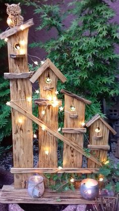 a birdhouse made out of wood with lights on it