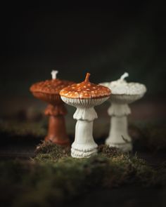 two small white and brown cakes sitting on top of each other next to each other