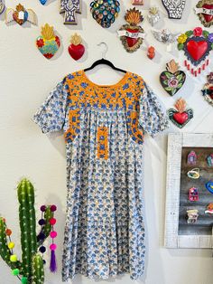 Our San Antonino dresses are unique, beautiful and perfect for any fiesta, a day at the beach or a formal event. You can easily dress it up or dress it down. Our dresses are completely hand embroidered by Artisans in Oaxaca, Mexico. It takes approximately 1 month to complete one dress.  Our San Antonino dresses are one of a kind. You will fall in love with every single detail. Each dress is hand embroidered on front chest area, sides and back with tiny floral designs inspired by the flowers in the region using beautiful color combinations. Crochet on sleeve and neckline. Across the chest, it has the "Hazme Si Puedes" (Make Me if You Can) technique, distinctive to their community. This intricate crochet technique shows tiny men and women lined together holding hands.  -Fabric & thread are 1 Multicolor Midi Dress With Floral Embroidery, Festival Floral Print Short Sleeve Dresses, Multicolor Embroidered Long Dress, Orange Embroidered Summer Dress, Multicolor Embroidered Floral Print Short Sleeve Dress, Short Sleeve Floral Print Dress With Multicolor Embroidery, Embroidered Multicolor Dress For Garden Party, Multicolor Floral Print Dress For Fiesta, Bohemian Floral Embroidered Dress