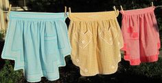 three different colored shorts hanging on a clothes line