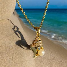 18K gold thick layered over High Quality Solid Stainless Steel. can be worn in water.  Our jewelry is made to last, anti-tarnish, higher durability than a regular gold-plated brass material, perfect for everyday wear. * Finish: 18K Gold * 18KGold Conch shell with white pearl * Featuring Adjustable Chain 16.5 inches to 18.5 inches. Length: 18.5 inch Material:Gold, tianiumsteel Pendant width: about 0.4 inch Pendant length: about 0.8 inch   all items are measured by handy, if has little size difference,  Please according to the real item size The sample picture is for display only. It can be personalized with any text and symbols. If you have any questions about this, please click on the question button next to the price and I will get right back to you. * All items are nicely packaged ready Beach Shell-shaped Shell With Pearl Pendant, Gold Strand Jewelry With Pearl Charm, Elegant Gold Strand Necklace, Gold Strand Necklace With Ocean-inspired Style, Gold Shell Necklace With Pearl Pendant For Beach, Gold Strand Necklace Ocean-inspired, Elegant Gold Strand Jewelry, Gold Ocean-inspired Strand Necklace, Ocean-inspired Gold Strand Necklace