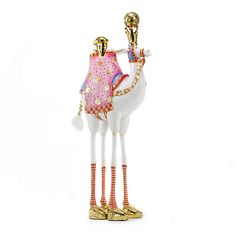 a glass figurine with a white and pink dress on it's head