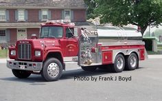 a red fire truck parked in front of a house