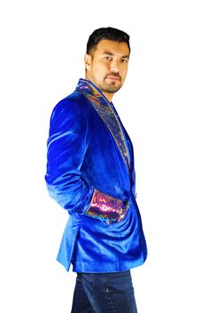 This mens royal blue velvet smoking jacket exudes a certain sophistication that other jackets can only dream of. We have taken this perfectly tailored,double breasted blazer to the next level with the addition of iridescent multi color flip sequins. FEATURES: Double breasted Fully lined with our signature satin 4 pockets including 1 inside breast pocket Reversible iridescent sequin contrast collar, cuffs and trim Velvet trimmed collar to for ultimate comfort Ethically made in-house in our studio Royal Fitted Blazer For Party, Single Breasted Velvet Suit For Party, Single-breasted Velvet Suit For Party, Party Velvet Single-breasted Suit, Luxury Velvet Outerwear For Party, Winter Party Blue Blazer, Velvet Party Suits For Winter, Royal Blue Party Blazer, Winter Velvet Party Suits