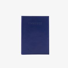 a blue passport case sitting on top of a white surface with the word passport printed on it