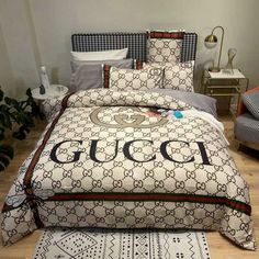 a gucci logo bed spread with matching pillows