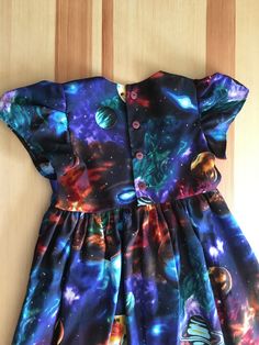 Girls Solar System Dress This lovely little dress is really OUT OF THIS WORLD with the planets on it and the flowing sleeves. Her favorite part that makes it better than her other dresses is that it is fully lined leaving no room for feeling uncomfortable! Makes for a terrific everyday dress! Buttons may vary. Any overage paid in shipping payment will be credited back to you upon shipping. Good News! We have more of the Galaxy fabric! If you would like a matching bonnet we would love to create i Fitted Flutter Sleeve Twirl Dress For Dress-up, Fitted Twirl Dress With Flutter Sleeves For Dress-up, Solar System Dress, Huion Tablet, Space Dresses, Summer Dress Short, Galaxy Fabric, Feeling Uncomfortable, Space Dress