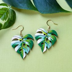 "Inspired by the Albo Borsigiana variegated monstera deliciosa, these unique heart shaped leaf earrings will add a luxurious botanical flair to your wardrobe or bring a personal hand-made touch as a gift to a loved one. These original earrings are hand painted on cherry wood with a beautiful patchwork palette of white and green. The subtle heart shape of the leaf adds even more character to an already unique pair of botanical earrings. Lightweight and durable, these detailed earrings are sure to Heart Shaped Leaf, Wood Hoop Earrings, Variegated Monstera, Monstera Albo, Laser Engraved Ideas, Botanical Earrings, Gold Leaf Earrings, Monstera Deliciosa, White Tiger