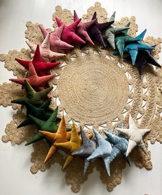 several different colored stars are arranged on a doily