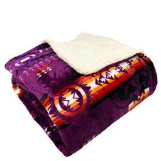 two blankets are stacked on top of each other, one is purple and the other is orange