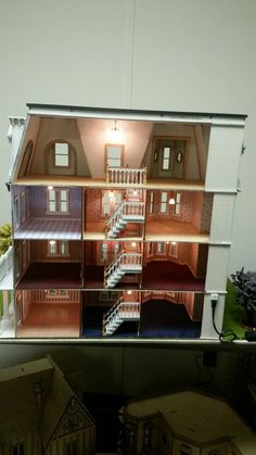 a doll house is shown with stairs leading up to the second floor and another room on the other side