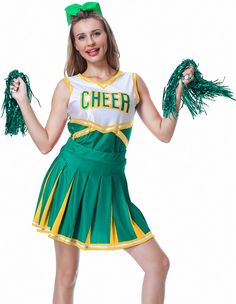 a woman in a cheer uniform holding two green pom poms