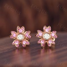 These flower style pink sapphire earrings shine with luminous elegance. They are sophisticated and chic. These tiny gold and gemstone earrings will be perfect addition to your stunning look and will make your beauty shine! Details Gemstone: Natural Pink Sapphire Middle stone: 2.5mm round cut Moissanite Each set comes with 2 post back earrings ◇◇Processing time◇◇ Any item on my store is handmade,made to order,no stock. Typically,it takes 2-3 weeks to complete the item. ◇◇Delivery time◇◇ --Domesti Pink Sapphire Earrings For Wedding, Gia Certified Pink Fine Jewelry Earrings, Wedding Pink Sapphire Earrings, Pink Gemstone Earrings In Flower Shape, Pink Diamond Earrings With Prong Setting For Wedding, Pink Gemstone Earrings With Flower Shape, Rose Gold Pink Sapphire Earrings As Gift, Rose Gold Pink Sapphire Earrings For Gift, Pink Gemstone Flower-shaped Earrings