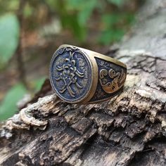 an ornate ring is sitting on top of a tree