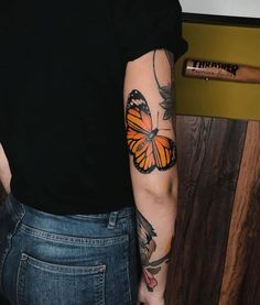 a woman with a butterfly tattoo on her arm