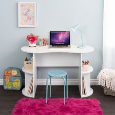 a white desk with a laptop on it and a pink rug in front of it