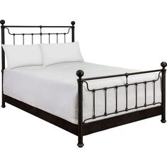 a black metal bed frame with white sheets