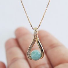 Discover the serene beauty of the Caribbean with our handcrafted Larimar pendant necklace. Each piece features a unique, ethereal blue stone, known for its calming properties, delicately set on a high-quality Gold filled chain. This elegant accessory adds a touch of sophistication to any outfit, making it perfect for both casual and formal wear. Larimar, a rare gemstone found only in the Dominican Republic, is renowned for its striking color and soothing energy. Our necklace is crafted with care and precision, ensuring that each Larimar stone's natural beauty is showcased. Ideal for gifting or as a special treat for yourself, this necklace is a unique piece that's sure to be cherished. ✤ Shipping ✤ I hand-make  each necklace you see in the picture and each piece it's ready to ship.  ✤ Care Elegant Light Blue Round Pendant Necklace, Elegant Round Aquamarine Necklace, Elegant Light Blue Necklaces With Natural Stones, Elegant Light Blue Necklace With Natural Stones, Elegant Light Blue Necklaces For Gifts, Elegant Aquamarine Round Pendant Jewelry, Fine Jewelry Light Blue Gemstone Necklace, Larimar Gemstone Pendant Necklace, Larimar Gemstone Pendant Necklaces