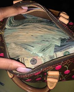 a person holding a purse full of money in their left hand and the inside of her wallet