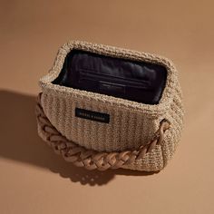 This exquisite Raffia Paloma Shoulder Bag is carefully crafted from luxuriously natural raffia intertwined with a slim leather and chain shoulder strap. Ornamented with a chunky acrylic chain for a unique touch, this timeless piece features a black lining and interior zipper pocket for extra security. Complete with a branded dust bag, this handbag is crafted with Italian finesse and is the perfect summer accessory. This new edition of this Paloma Bag has been updated so that the acrylic chain ca Chic Beige Braided Straw Bag, Chic Beige Braided Bag, Chic Braided Beige Bags, Rectangular Straw Bag With Chain Strap For Vacation, Chic Rectangular Straw Bag With Detachable Strap, Elegant Rectangular Straw Bag With Chain Strap, Chic Rectangular Braided Straw Bag, Brown Vacation Bag With Chain Strap, Elegant Natural Straw Bag With Detachable Strap