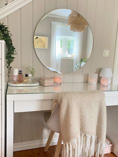 a white desk with a mirror and some lights