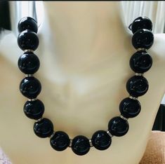 Vintage 1960's  silver and black beaded necklace.  The mid century  necklace has 2 inch black beads with alternating silver rings.  The clasp is marked gsilver or commonly called nickel silver on this 19 inch long necklace. Mint condition and comes in a gift box. Shop more of our vintage jewelry go to https://www.Etsy.com/shop/Historicallyhers Black Beaded Necklace For Formal Costume Jewelry, Formal Black Beaded Costume Jewelry Necklace, Black Beaded Costume Jewelry Necklace For Formal Occasions, Formal Black Beaded Costume Necklace, Formal Black Necklace With Large Beads, Black Round Bead Costume Necklaces, Black Round Beads Costume Necklace, Formal Black Jewelry With Large Beads, Black Round Beaded Costume Jewelry Necklace