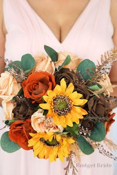 a bride holding a bouquet of sunflowers and roses