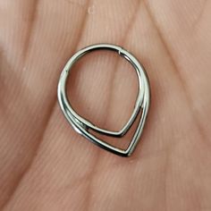 a silver ring sitting on top of a person's hand