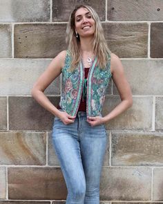 "The Floral Jacquard Waistcoat has a French designer charm about it. The flowery patterns with its bold hand beaded edges feels like it is right out of a 1970s Fashion magazine! The carefully curated jacquard fabric with its trendy autumn weave, makes this the perfect accessory for your fashionable fall outfit! The buttery soft satin lining and its front tie up adds a strong artsy vibe to it and makes it sooo comfortable to wear! Match it with a dress or with jeans, this is a very chic piece. Me Sleeveless Spring Outerwear With Floral Embroidery, Sleeveless Outerwear With Floral Embroidery For Spring, Sleeveless Floral Embroidery Spring Outerwear, Sleeveless Floral Embroidered Spring Outerwear, Vintage Spring Vest Outerwear, Sleeveless Festival Outerwear, Bohemian Sleeveless Embroidered Outerwear, Fitted Sleeveless Outerwear With Floral Embroidery, Fitted Sleeveless Floral Embroidered Outerwear