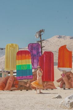 a woman standing in front of ice cream pops