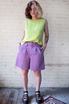 "Fabulous purple high waisted shorts made by 'Baxter and Wells'. Pleated trouser style shorts that fall to the mid thigh. Has three pockets in the front and one in the back. Shorts have an elastic back that gives some flexibility to the waist; zipper and single button closure.  Very good to excellent vintage condition with no stains or flaws of note. Marked women's size 12, see the full measurements below. Please feel free to reach out with any sizing questions that you may have. Measurements (t Retro Bermuda Shorts For Summer, Retro Green Shorts For Spring, Retro Bermuda Shorts For Spring, Vintage Short Pants For Spring, Retro Knee-length Shorts For Summer, Vintage Shorts With Short Inseam For Summer, Retro Relaxed Fit Short Leg Bottoms, Vintage Summer Workwear Bottoms, Retro Style Shorts With Relaxed Fit