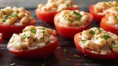 three stuffed tomatoes are sitting on a plate