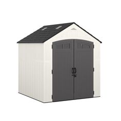 a white and gray shed with a black roof