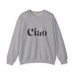 Stay warm and stylish with the Ciao Sweatshirt! The ribbed collar and medium-heavy fabric blend of cotton and polyester provide ultimate coziness. No more itchy side seams, thanks to the tear-away label. Available in sand, gray, or white from Gildan. Made using 100% ethically grown US cotton. Gildan is also a proud member of the US Cotton Trust Protocol ensuring ethical and sustainable means of production. The blank shirt's dyes are OEKO-TEX-certified dyes with low environmental impact. Fabric b Beige Cotton Sweater With Letter Print, Gray Cotton Sweater With Ribbed Neckline, Bling Bags, Custom Design Shoes, Bling Shoes, Environmental Impact, White Sweatshirt, Heavy Fabric, No More