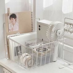 a white desk with various items on it and a photo in the backround