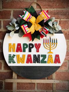 a sign that says happy kwanza with a menorah