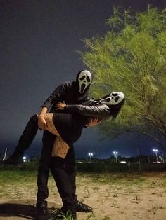 a man in a skeleton mask is holding another man