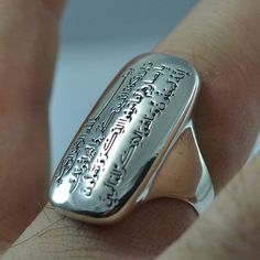 This empower sterling silver ring had engraved 52 & 53 ayats of Surah QALAM OF Holly QURAN, it is a very special ayat for Evil Eye Nazar Protection. The engraving is very clear and accurate. The ayats has written on the ring by high quality laser engraved. It will not erase by using. - Material: Sterling Silver 925 - The ring weight is approx.7.94 grams - Featuring 15 mm x 29 mm oval signet. - The bottom of the ring across the finger 1.5 mm thick and 3.5 mm wide, making it comfortable to wea Spiritual Engraved Ring With Polished Finish As A Gift, Spiritual White Gold Engraved Ring With Polished Finish, Spiritual Engraved Ring For Anniversary With Polished Finish, Silver Symbolic Jewelry With Engraved Text, Sterling Silver Spiritual Engraved Ring, Spiritual Silver Engraved Ring With Engraving Option, Silver Rectangular Promise Ring, Silver Rectangular Engraved Sterling Silver Ring, Rectangular Silver Engraved Ring Stamped 925