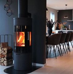 a stove that is sitting in the middle of a living room next to a table