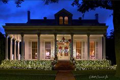 a large white house with christmas lights on it