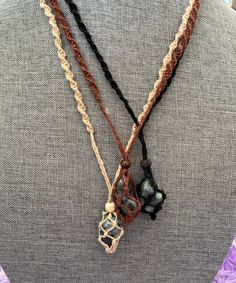 These one of a kind hemp macramé necklaces come in three colors: black, brown and tan, with one emerald stone. The necklace is 12-13 inches in length. None are exactly the same!! When you receive your necklace, it will be prefilled with one Emerald crystal and will arrive safely in a pretty mesh pouch. Also included are crystal care and cleansing instructions along with a crystal properties card. All the Crystals I sell are cleansed, charged & well cared. They're perfect for metaphysical use Adjustable Earthy Necklaces With Waxed Cord, Earthy Handmade Necklace With Waxed Cord, Earthy Macrame Jewelry With Waxed Cord, Handmade Brown Cord Jewelry, Adjustable Macrame Crystal Necklace With Waxed Cord, Adjustable Macrame Necklace In Nature-inspired Style, Natural Colored Necklace With Adjustable Waxed Cord, Nature-inspired Adjustable Macrame Necklaces, Handmade Black Earthy Jewelry