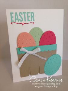 an easter card with eggs in a basket on the front, and a bow at the back