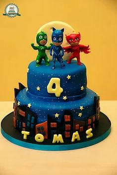 a three tiered cake with the number four on it's side and two cats standing on top