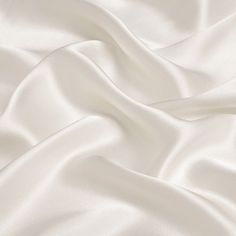 19mm silk satin fabric, 114cm wide, ivory white color. 100％ silk. How to care silk fabric: Washing: hand washing is advice 30 degrees, silk is a nature protein fiber so don't use harsh detergents that contain bleaches or brighteners, use only PH neutral detergent. Soaking silk for any more than afew minutes should be avoided. Drying: don't wring or twist, roll in towel to extract water. Avoid drying silk in direct sunlight. Any questions or comments on silk fabric, please let us know. Satin Fabric Images, Brilliant White Fabric, Luxury White Silk Evening Dress, Silk White Blanket, Whitw Satin Wallpaper, Satin Wallpaper Silk Beige, Luxury Elegant White Tulle Fabric, White Silk Blanket Wallpaper, Luxury White Silk Embroidered Fabric