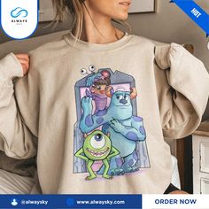 a woman wearing a sweatshirt with monsters on it