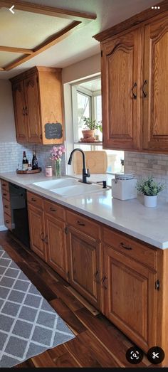 a kitchen with wooden cabinets and white counter tops