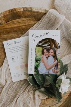 two wedding photos on top of a wooden bowl with flowers and greenery next to it