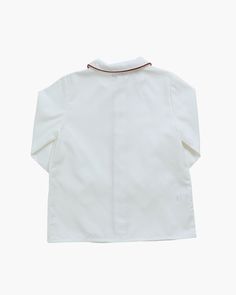 Our iconic Daniel Shirt offers a sleek and stylish look tailored from soft white poplin cotton with contrasting red piping on the sleeves, collar and placket. Delicate mother-of-pearl button front fastening, adding a special touch to keep your little boy stylish, comfortable and cool throughout the season. Perfectly versatile, it pairs beautifully with shorts, trousers and our classic boy shoes for a polished and refined look. Ideal for any occasion, the Daniel Shirt combines classic charm with Hand Smocked Dress, Baby Boy Shirts, Girls Special Occasion Dresses, Hand Smock, Christening Gowns, Boy Shoes, Dress Gift, Mother Of Pearl Buttons, Smock Dress