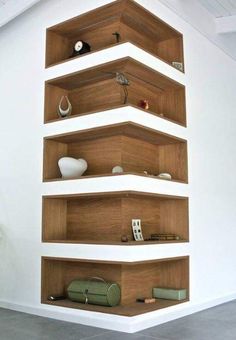 there is a shelf with many items on it in the room that looks like shelving